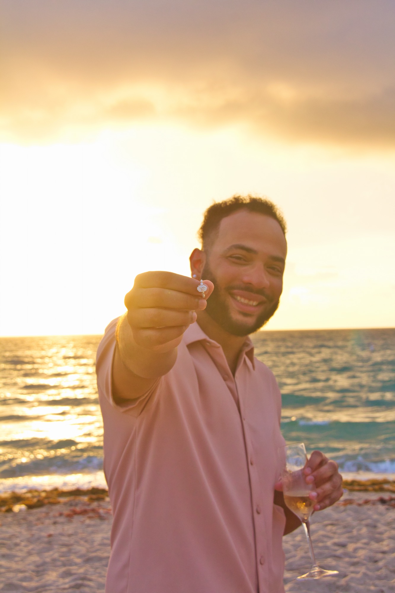 David holding up the ring at sunset
