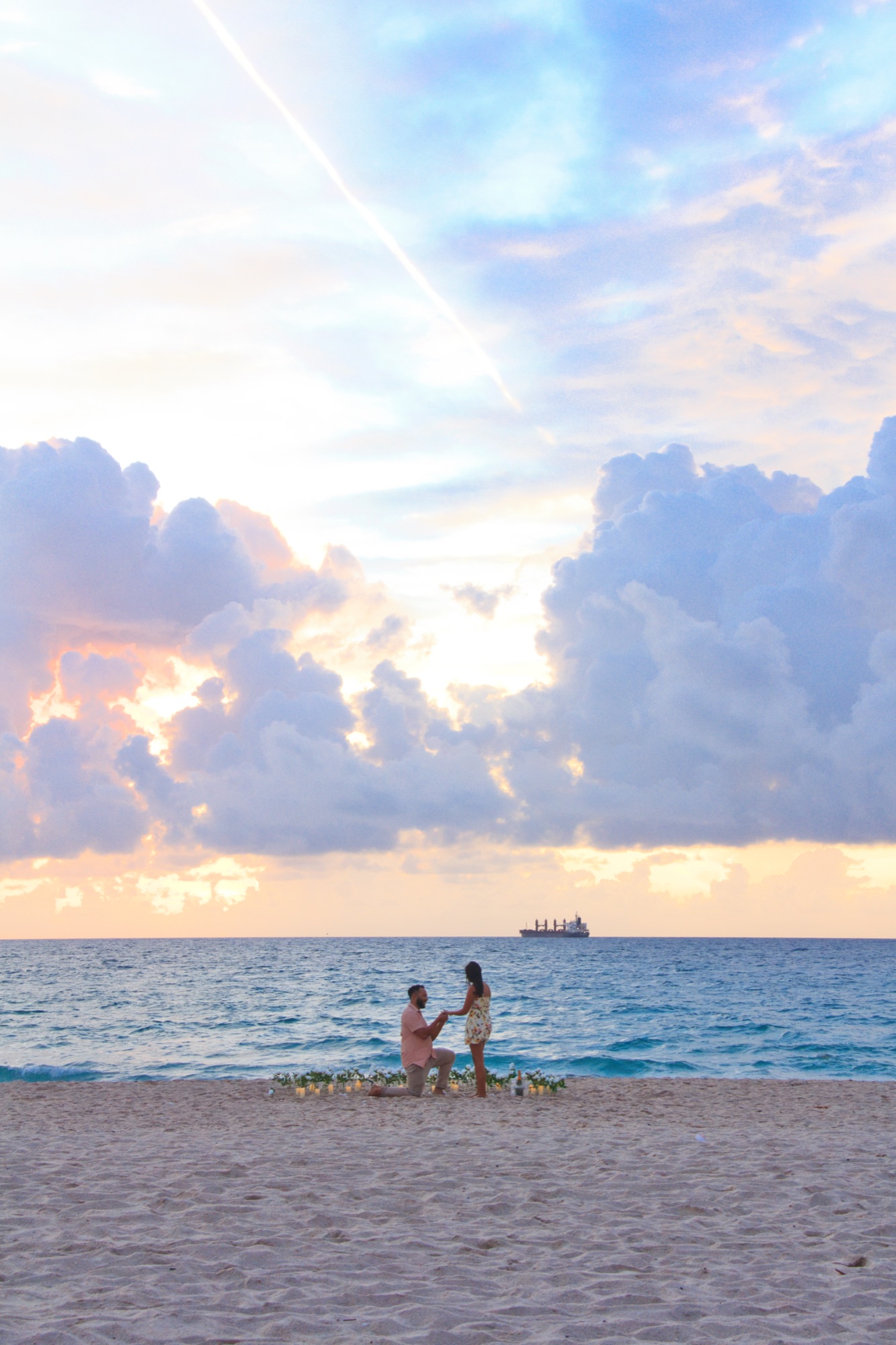 David proposing to Shriya on the beach at sunset